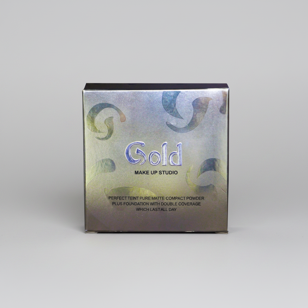 A square metallic compact powder box for Gold Make Up Studio, featuring a holographic silver and blue finish with gold swirl patterns, set against a neutral gray background.